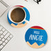Personalized teacher coaster placed next to coffee and workspace items. Demonstrates practical everyday use.