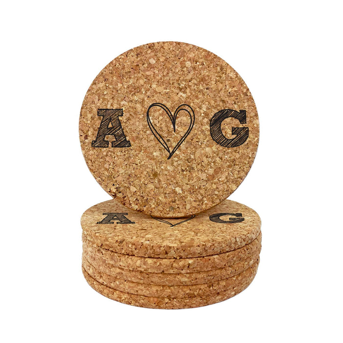 Stack of round cork coasters featuring a hand-drawn heart initial design on a white background.
