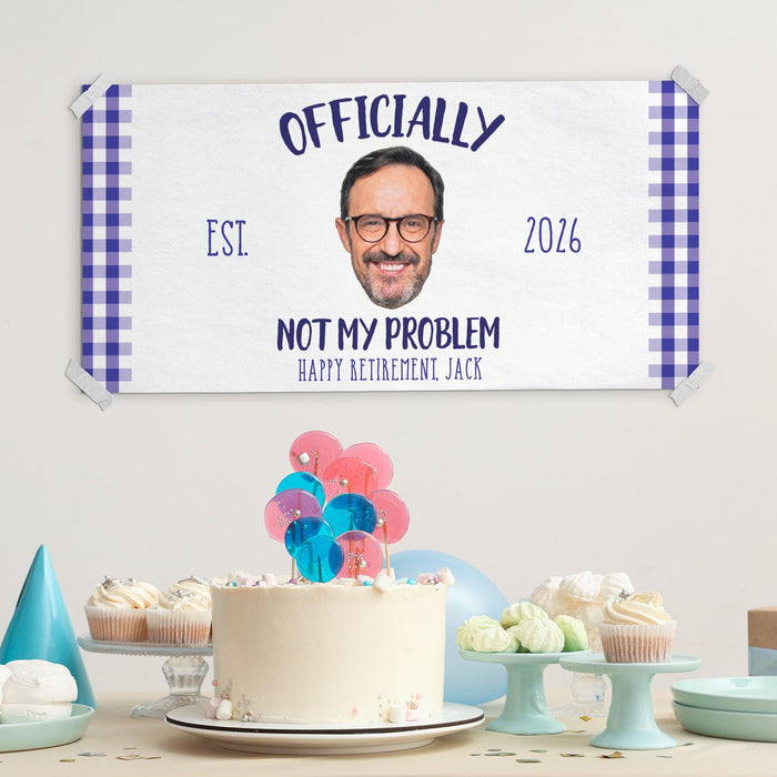 Personalized retirement banner displayed above a celebration table with cake and party decorations. Fun retirement party sign customized with photo, name, and year.