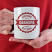 Custom Grandpa mug held in hand with Certified Grandpa and established year design.
