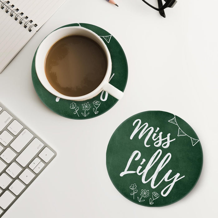 Chalkboard style coaster placed next to coffee and workspace items. Shows practical daily use.