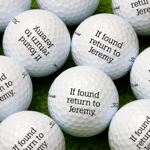 a collection of golf balls with the text "If found return to Jeremy." printed on them.