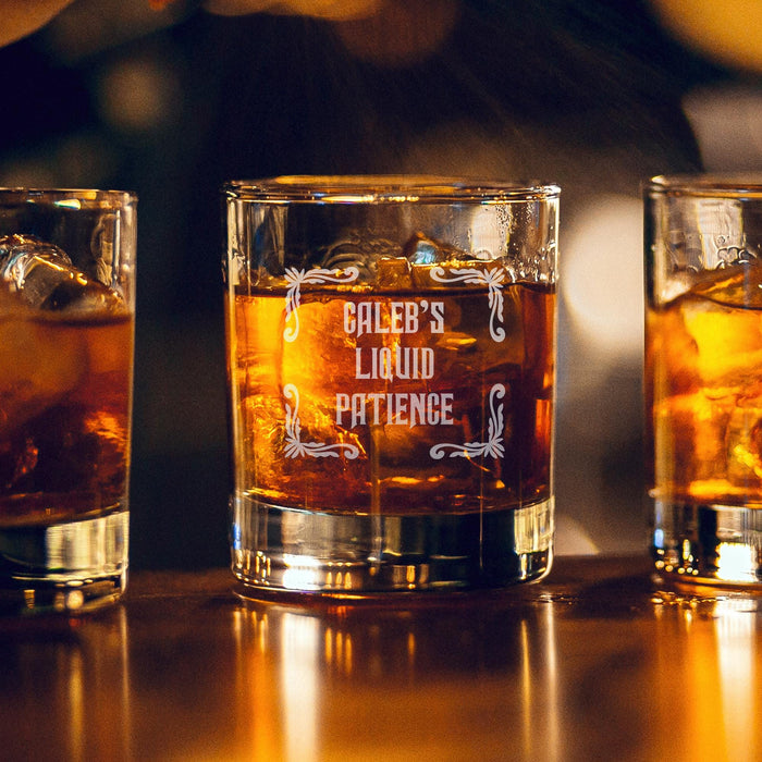 Warm bar-style lifestyle image of a personalized whiskey glass with glowing ambient lights in the background, featuring the “Caleb’s Liquid Patience” engraved design. The rich whiskey tones and soft lighting create a premium lounge-inspired presentation.
