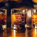 Warm bar-style lifestyle image of a personalized whiskey glass with glowing ambient lights in the background, featuring the “Caleb’s Liquid Patience” engraved design. The rich whiskey tones and soft lighting create a premium lounge-inspired presentation.