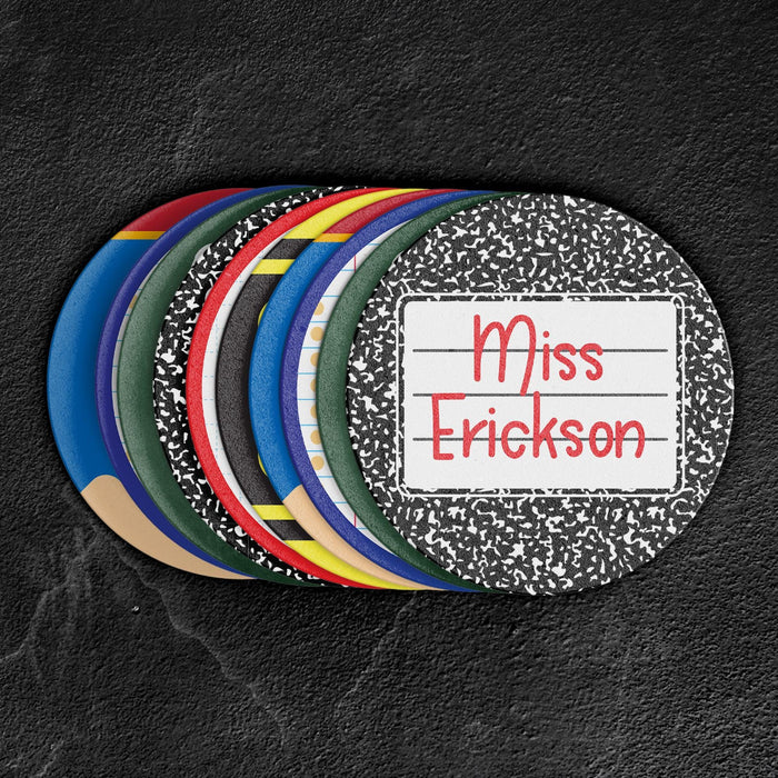 Stack of colorful personalized teacher coasters in multiple designs. Shows variety and thickness of the coasters.