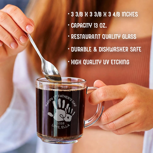 A person is holding a glass mug with a message engraved on it. The image is accompanied by a text overlay that reads • 3 3/8 x 3 3/8 x 3 4/8 inches • Capacity 13 oz. • restaurant quality glass • durable & dishwasher safe • high quality uv etching