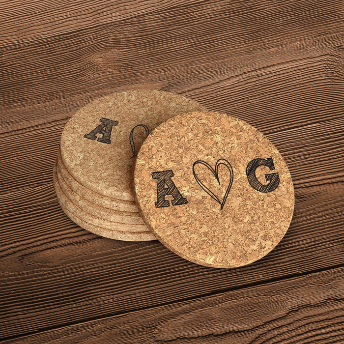 Round cork coasters featuring a hand-drawn heart monogram and personalized initials on a wood table.