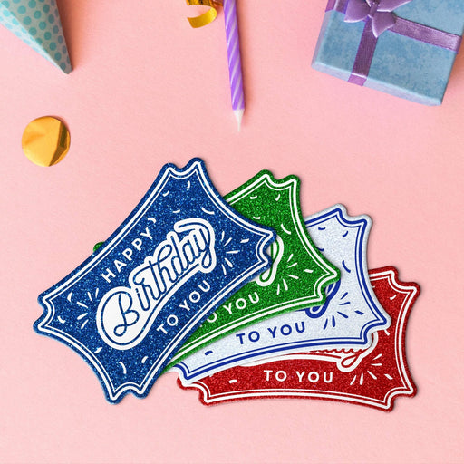 Four birthday slim rectangle tags in glitter red, glitter blue, glitter green, and glitter white.