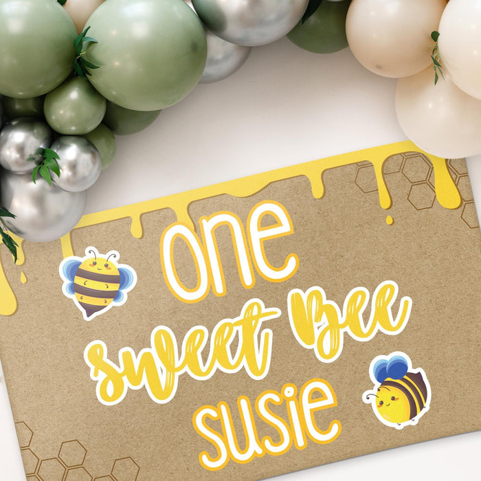 Angled view of the personalized birthday banner highlighting the honey drip details, bee illustrations, and custom name personalization.