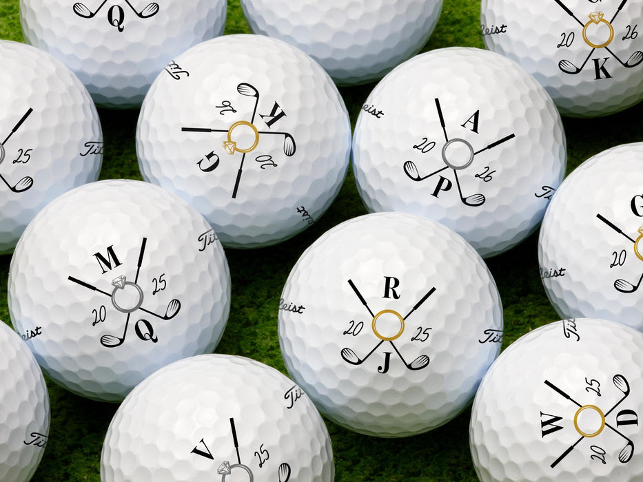 Multiple Titleist golf balls shown with different initials and dates on each ball. Golf balls sit on a grassy surface.