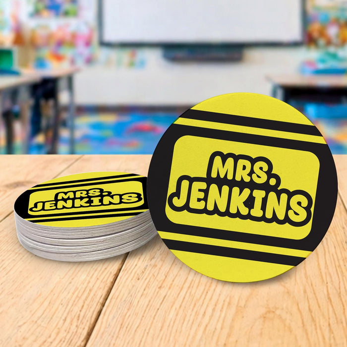 Personalized teacher coasters displayed in a classroom setting. Demonstrates real-life teacher desk use.