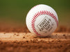 Baseball sits on field. Baseball has First Father's Day design engraved on it.