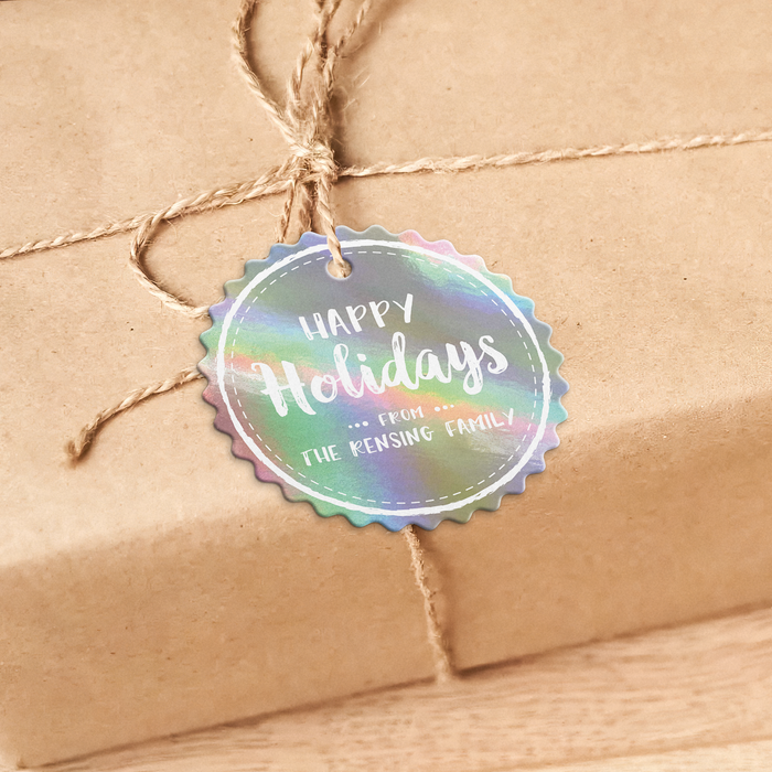 A brown gift box with a round tag attached, tied with twine, and a message that reads "Happy Holidays from the Rensing Family".