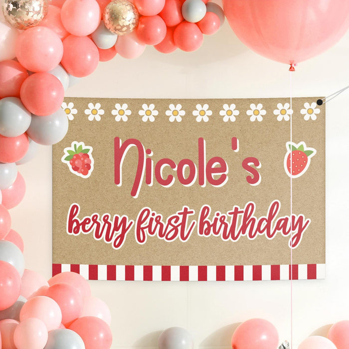 Personalized berry first birthday backdrop styled with pink balloons and party décor for a sweet first birthday celebration.
