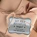 Personalized “Let Your Adventure Begin” wedding gift tag attached to kraft paper wrapping using natural twine. The metallic silver foil finish creates an elegant keepsake-style presentation.