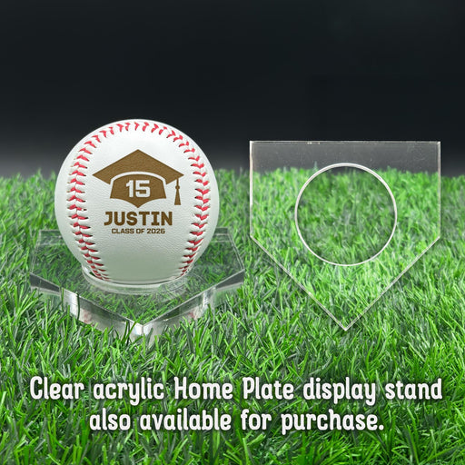 A personalized baseball with red stitching is placed on a clear acrylic stand, accompanied by a text overlay that reads Clear acrylic Home Plate display stand also available for purchase.