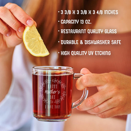 A person is holding a glass mug with a message engraved on it. The image is accompanied by a text overlay that reads • 3 3/8 x 3 3/8 x 3 4/8 inches • Capacity 13 oz. • restaurant quality glass • durable & dishwasher safe • high quality uv etching