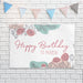 Personalized floral banner displayed on a white brick wall with decorative party bunting.
