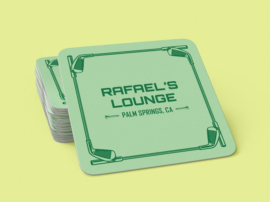 A stack of custom square pulpboard coasters are shown on a yellow background. The custom coasters feature a green golf bar design with interlocking golf clubs used as a border. The bar name and location can be customized.