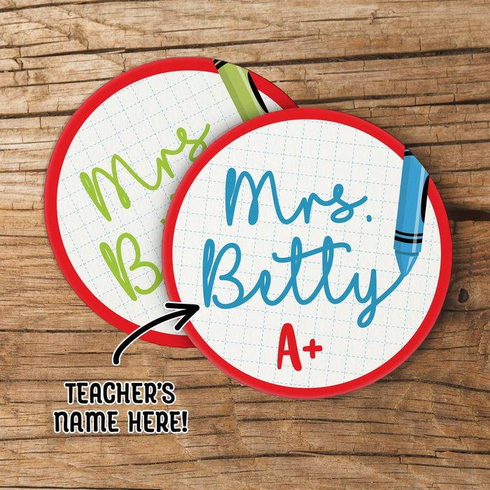 Personalized teacher coasters with custom name shown on a wood background. Demonstrates design and personalization placement.