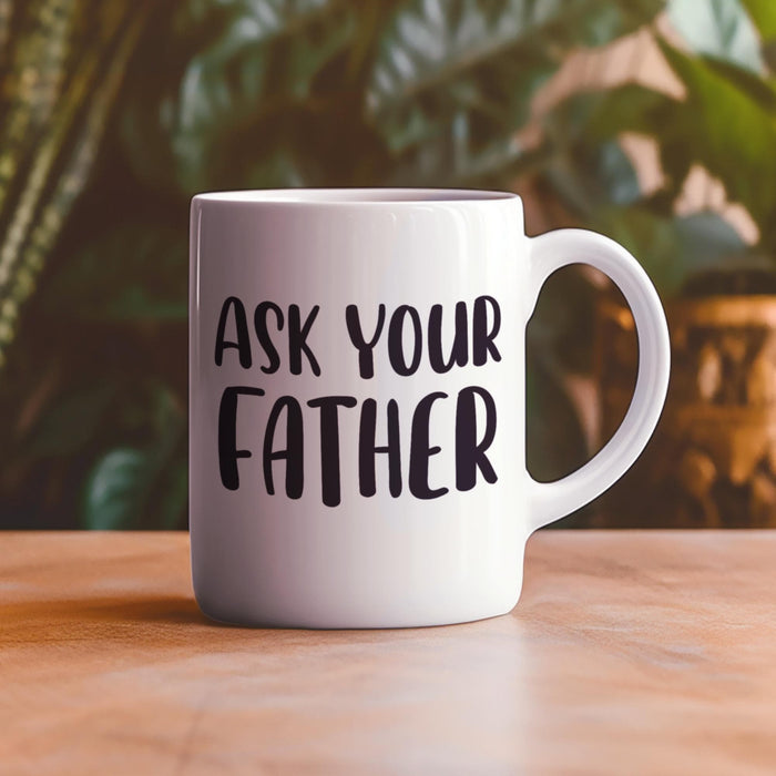 “Ask Your Father” mug displayed outdoors on a warm wooden table with soft greenery in the background. A relaxed lifestyle mockup perfect for Father’s Day gifting.