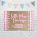Little Miss ONE-derful birthday backdrop displayed against a white brick wall showing the printed butcher paper material and bright pink design.