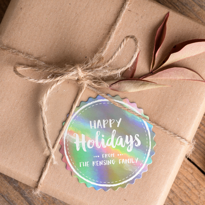 A brown gift box tied with twine and adorned with a Christmas gift tag that reads "Happy Holidays".
