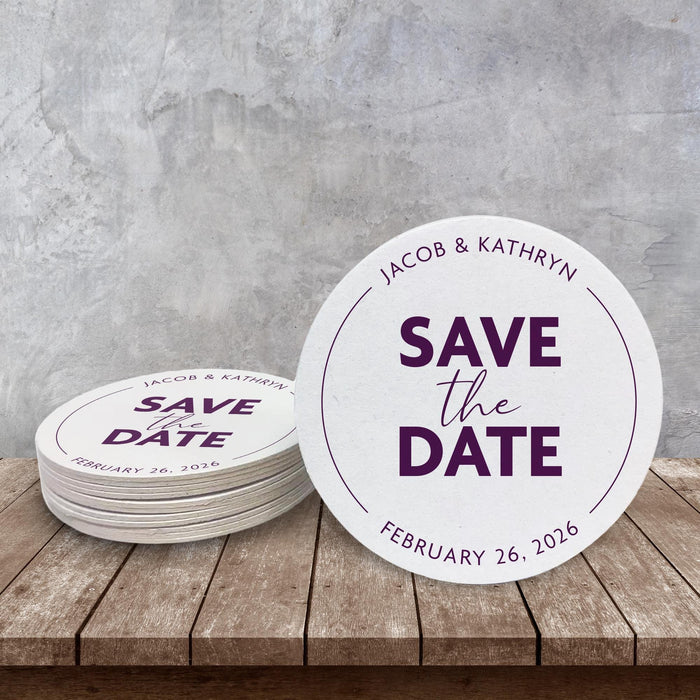Custom Save the Date coaster displayed on a rustic wood surface. Features a clean modern layout with personalized wedding details.