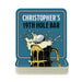 A blue coaster with a graphic of a beer mug and a golf ball, along with the text "CHRISTOPHER'S 19TH HOLE BAR".