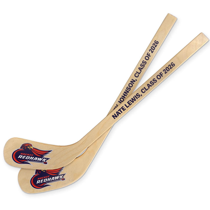 Two personalized hockey sticks displayed together showing custom team logos and text printed on the blade and handle.