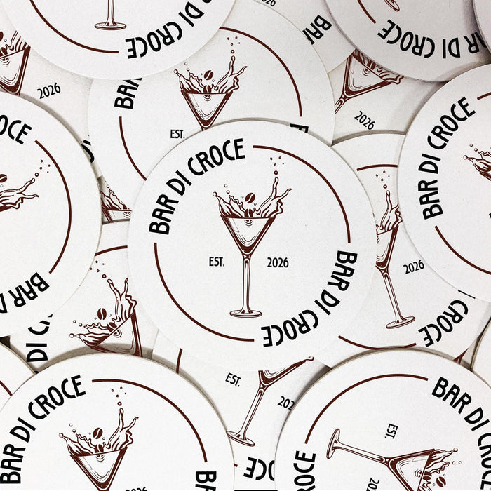 Multiple round espresso martini coasters arranged together, each featuring the personalized bar name, espresso martini glass design, and established year.