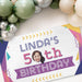 Personalized retro birthday banner displayed beneath a balloon garland, featuring a custom name, age, and face cutout.