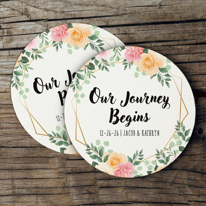 Personalized floral wedding coasters featuring a botanical frame and custom wedding details. Elegant wedding favors for guests.
