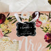 Romantic floral flat lay featuring a personalized “Let Love Sparkle” gift tag in metallic silver foil. Styled with flowers and soft wedding décor for bridal shower inspiration.