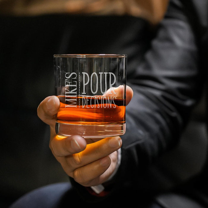 Close-up lifestyle photo of a personalized whiskey glass held in hand, featuring the “Mike’s Pour Decisions” engraved design. The glass is filled with whiskey and ice, creating a premium gift presentation perfect for whiskey lovers.