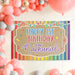 Rainbow themed first birthday banner displayed with colorful party balloons and decorations for a bright birthday celebration.