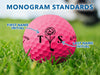 Monogram standards for designs shown with arrows pointing to both the first name initial and last name initial. First name initial is on the right and last name initial is on the left. Design is seen on a pink Callaway golf ball on a golf course.