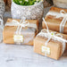 Wrapped wedding gifts tied with ribbon and decorated using personalized “Let Love Sparkle” foil gift tags. The tags add a polished finishing touch to bridal shower and wedding presents.