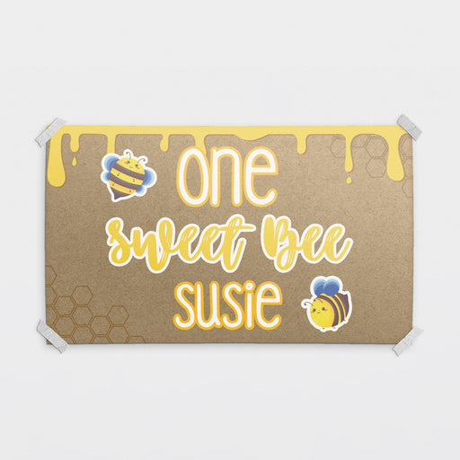 Personalized One Sweet Bee birthday banner printed on brown butcher paper with honey drip graphics, cute bee illustrations, and custom name personalization.
