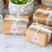 Wrapped wedding gifts tied with ribbon and decorated using personalized “With Love” foil cardstock tags. Adds a polished finishing touch to bridal shower and wedding presents.