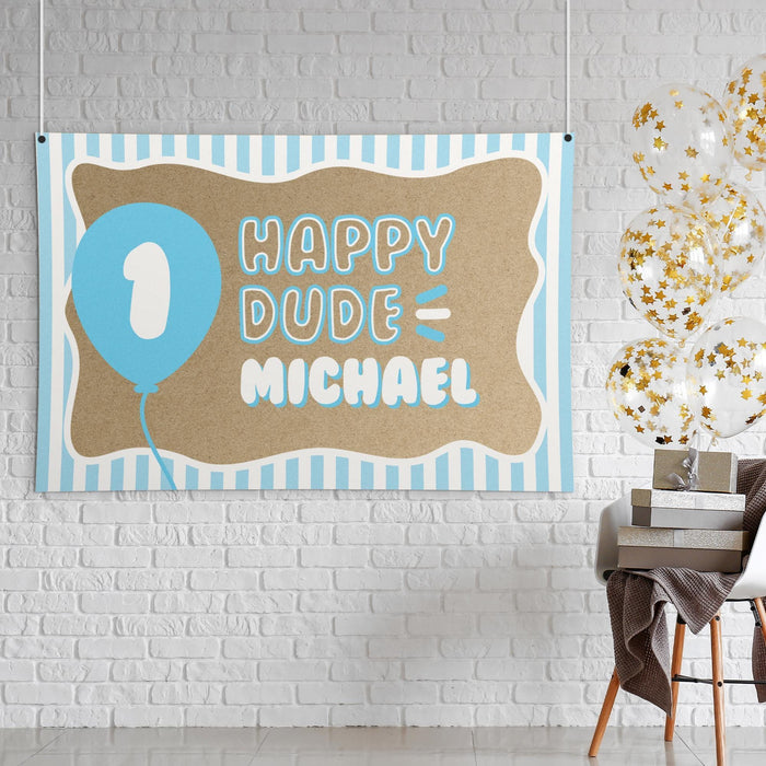 Close-up styled display of the ONE Happy Dude banner showing the butcher paper texture, soft blue colors, and playful first birthday theme.