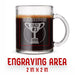 A glass mug with an engraved design on it. The mug is filled with tea, and there is text under the mug that reads "Engraving Area is 2 in x 2 in”