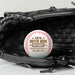 A baseball with a personalized message is placed inside a black leather baseball glove.
