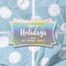 Personalized Happy Holidays slim rectangle gift tag displayed on blue and white polka dot holiday wrapping paper.