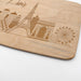 Close-up of the laser engraved Paris skyline featuring the Eiffel Tower and other city landmarks on maple wood.
