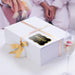 White gift bags with tissue paper decorated using personalized “Your Biggest Fans” holographic foil wedding gift tags. A stylish option for wedding welcome bags, bridal party gifts, and favors.