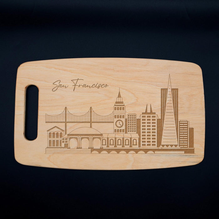 Full view of the San Francisco skyline cutting board on a dark background with the laser engraved city design clearly visible.