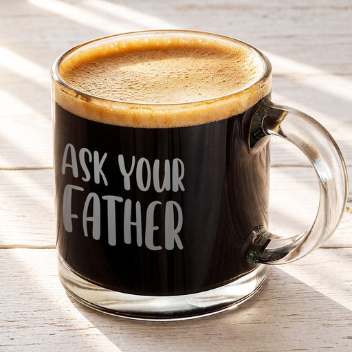 Glass mug filled with coffee and topped with light foam, featuring the “Ask Your Father” engraved design. A warm lifestyle image perfect for morning coffee inspiration.