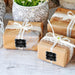 Small wrapped gift boxes tied with ribbon and decorated using personalized “Let Love Sparkle” wedding gift tags. Elegant packaging idea for weddings and engagement celebrations.