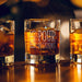 Warm bar-style lifestyle image of the personalized whiskey glass with glowing ambient lights in the background. The “Mike’s Pour Decisions” engraving is highlighted beautifully, creating a premium lounge-inspired presentation.